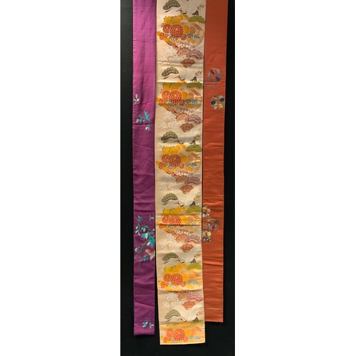 144 - Fashion & Textiles - A Japanese Kimono decorated with butterflies and flowers upon a russet and blue... 