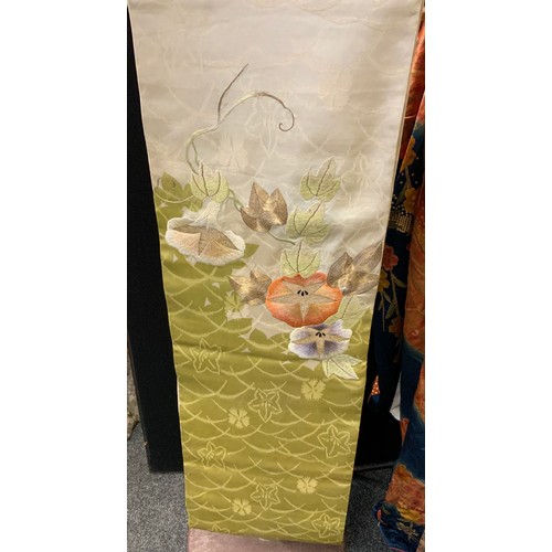 144 - Fashion & Textiles - A Japanese Kimono decorated with butterflies and flowers upon a russet and blue... 