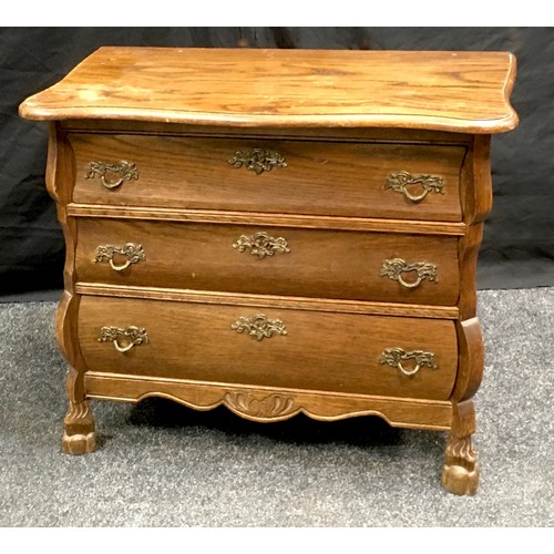 203 - An oak veneered three drawer commode chest