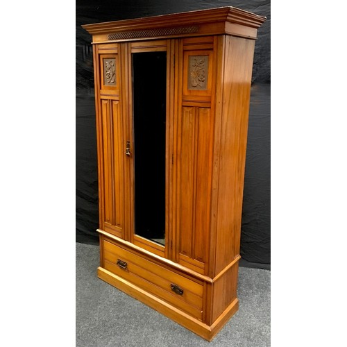 207 - An Edwardian satin walnut wardrobe, stepped cornice, carved frieze, central mirrored door flanked by... 