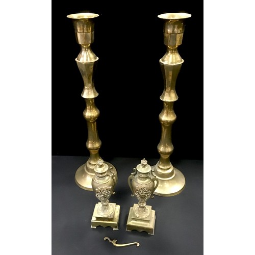 188 - A large pair of brass alter type candlesticks; two brass urns (4)