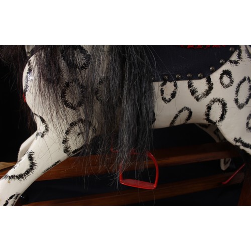 5181 - A mid-20th century children's rocking horse of small proportions, the carved and dapple painted hors... 
