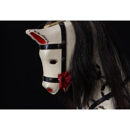 5181 - A mid-20th century children's rocking horse of small proportions, the carved and dapple painted hors... 