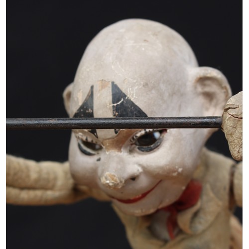 5202 - A late 19th/early 20th century novelty mechanical toy in the form of a clown or acrobat, painted pap... 