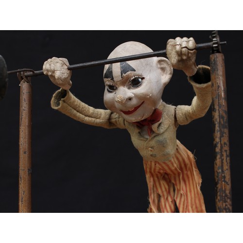 5202 - A late 19th/early 20th century novelty mechanical toy in the form of a clown or acrobat, painted pap... 