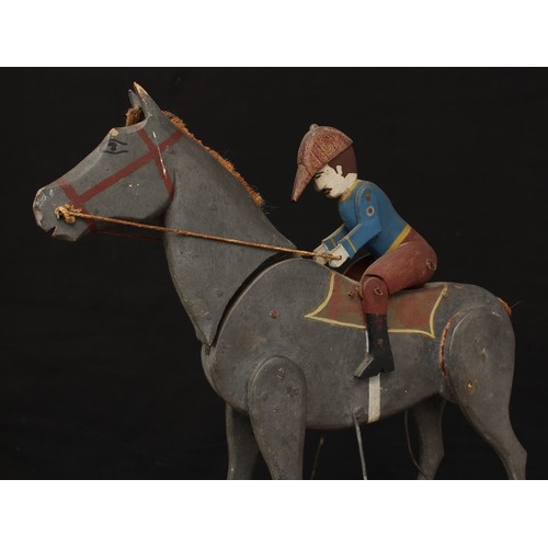 5203 - Folk Art - an early 20th century painted wooden novelty pull along toy, in the form of a Horse and j... 