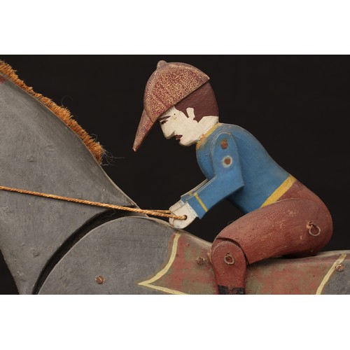 5203 - Folk Art - an early 20th century painted wooden novelty pull along toy, in the form of a Horse and j... 