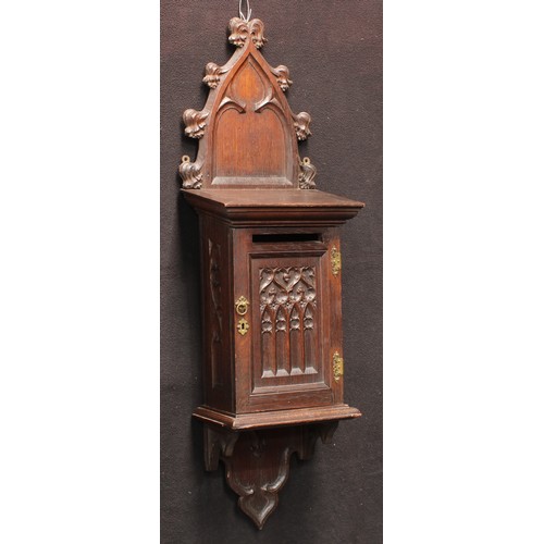 3049 - A 19th century Gothic Revival oak wall mounted country house post box, shaped cresting, moulded corn... 