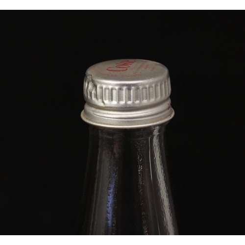 5466B - Advertising - an unusual stretched and twisted novelty glass Coca-Cola bottle, silver screw top lid,... 