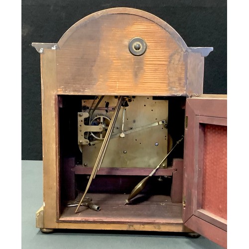 57 - A mahogany dome top mantel clock, arched face, Roman numerals, flanked by barley twist columns, bun ... 