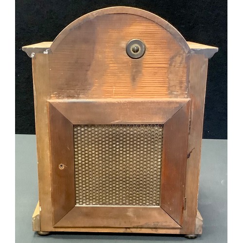 57 - A mahogany dome top mantel clock, arched face, Roman numerals, flanked by barley twist columns, bun ... 