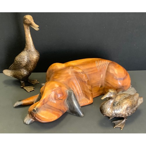 58 - A Bronzed metal model Duck another;  bronze coloured Indian Running;  a large carved wooden recumben... 