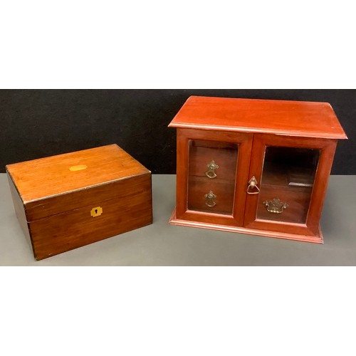 101 - An Edwardian mahogany two door smokers cabinet, fitted with an arrangement of four drawers, 25cm hig... 