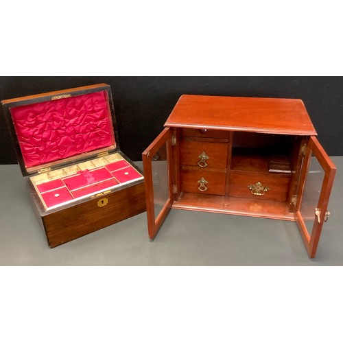 101 - An Edwardian mahogany two door smokers cabinet, fitted with an arrangement of four drawers, 25cm hig... 
