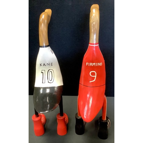 95A - A wooden duck, standing, wearing football shirt, 47cm high;  another (2)