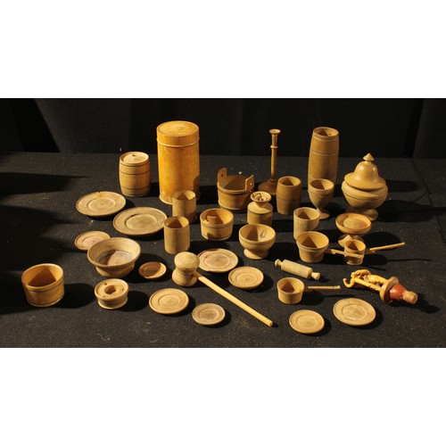 186 - Treen - a collection of boxwood miniature domestic vessels and utensils, various trenchers, a butter... 