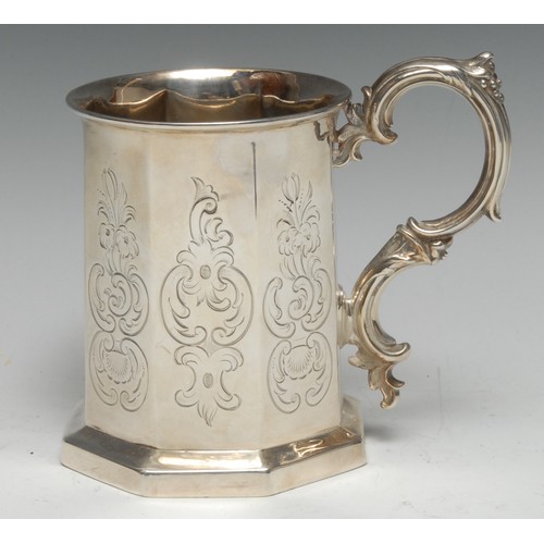170 - A Victorian Gothic Revival silver octagonal mug, engraved with leafy C-scrolls and cartouches, folia... 