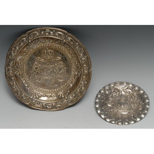 158 - A Portuguese silver coloured metal circular dish, centred by double-headed eagle and armorial, the b... 