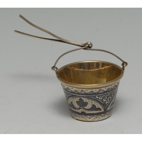 160 - A Russian silver and niello bucket shaped tea strainer, gilt interior, 2.5cm high, early 20th centur... 