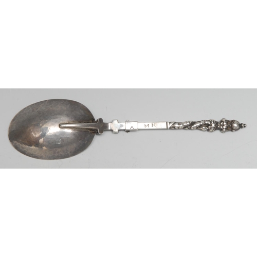 196 - An 18th century Continental silver folding travelling spoon, cast herm finial, hatched ownership ini... 