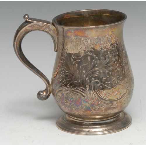 168 - A small George II silver baluster mug, later monogrammed and chased with flowers and leafy C-scrolls... 