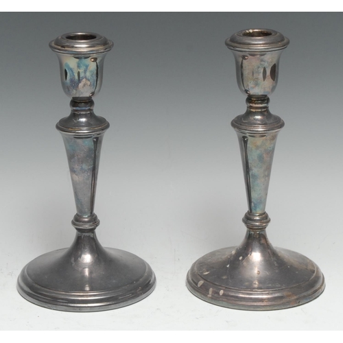 140 - A pair of Elizabeth II silver table candlesticks, urnular sconces, tapered pillars, spreading circul... 