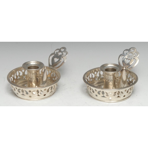 155 - A pair of unusual William IV silver circular chambersticks, pierced sconces, borders and handles, 12... 