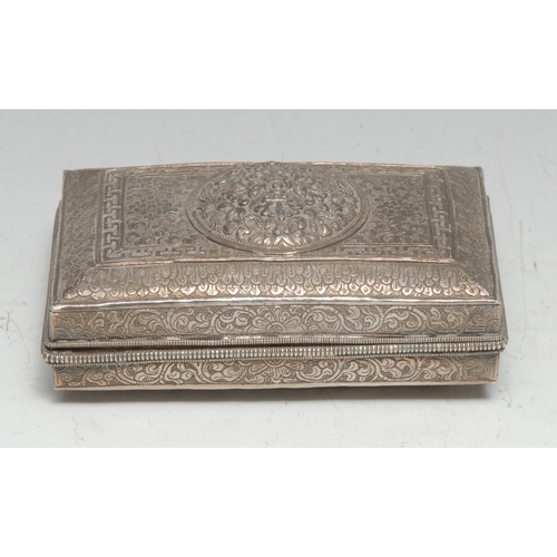 169 - A Tibetan silver rectangular box, profusely chased and engraved with lotus and bands of trellis, hin... 