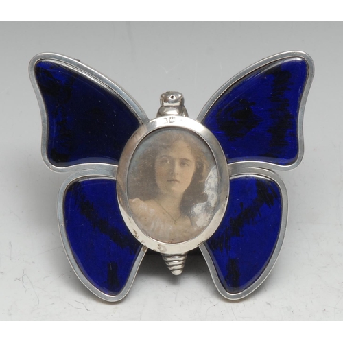 174 - A Victorian silver and enamel novelty easel photograph frame, as a butterfly, oval aperture, 11.5cm ... 
