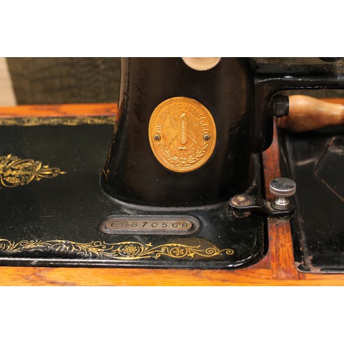 A cased Singer sewing machine, the case is faux crocodile skin