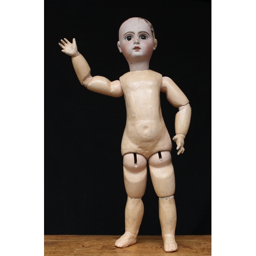 2011 - A bisque head and painted composition bodied doll, inset fixed brown glass eyes, painted features in... 