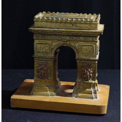 64 - A cast desk model, of L'Arc de Triomphe, 18.5cm high over stand