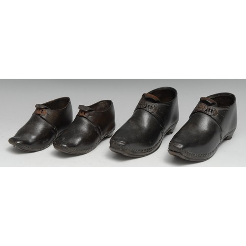 83 - Costume - a graduating pair of early 19th century children's black leather shoes or boots, cold-pain... 