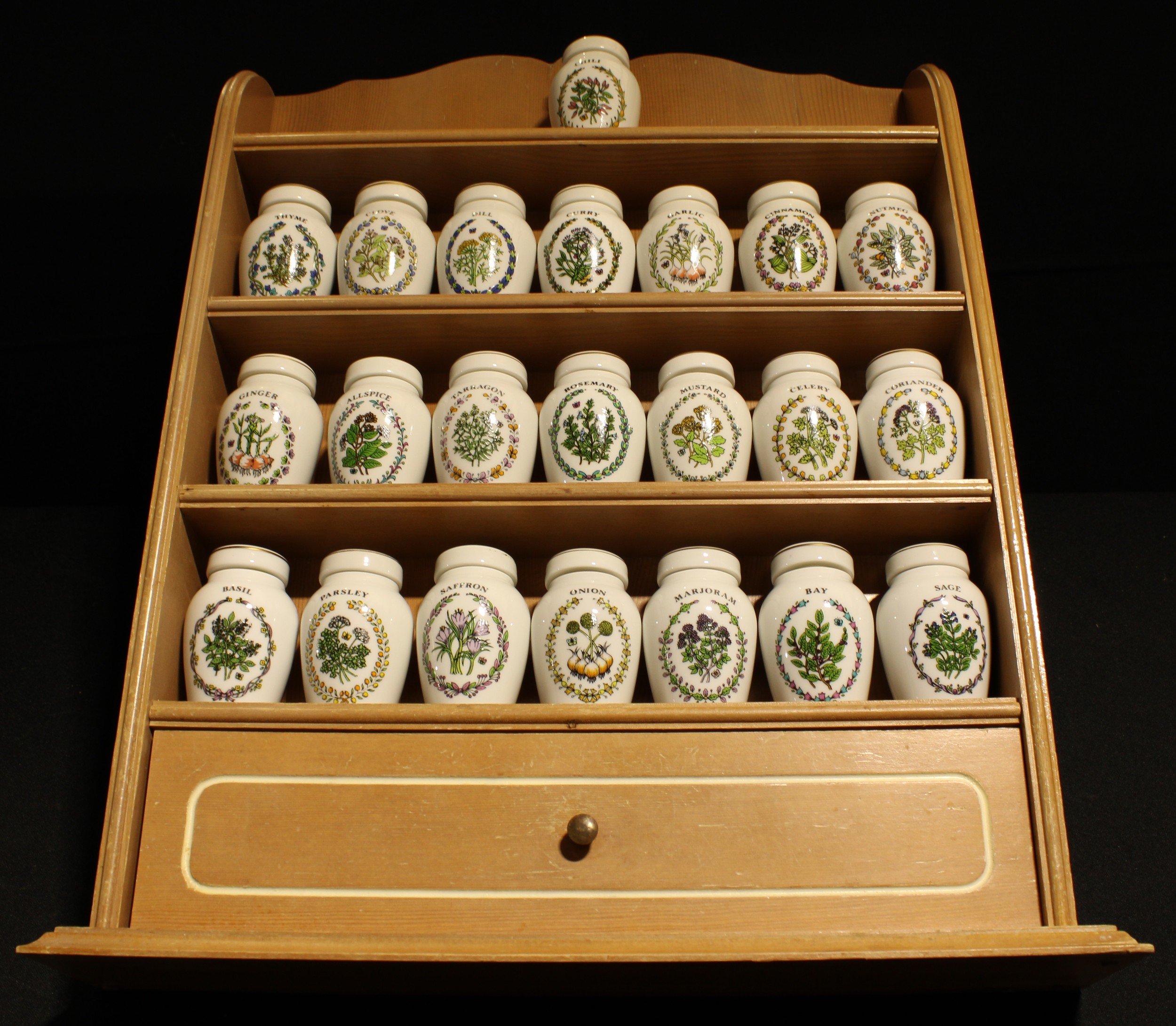 A set of twenty two Franklin Mint spice jars on kitchen rack