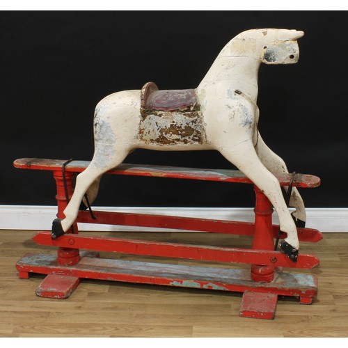 2014 - A late 19th/early 20th century English rocking horse on safety stand, the partially stripped and car... 