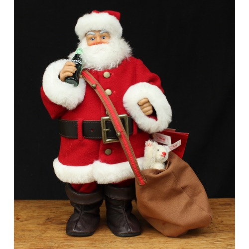 2156 - Steiff (Germany) 670350 Coca-Cola Santa Clause doll, he stands in red costume with a bottle of Coca-... 