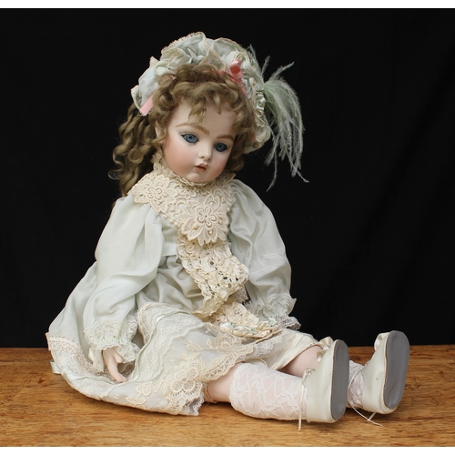 2159 - A reproduction Bru bisque head and shoulder doll, partially stuffed cloth body with bisque arms and ... 