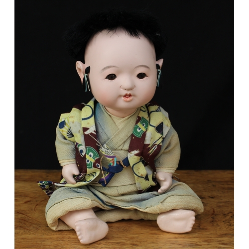 2166 - A Japanese Ichimatsu composition head and painted composition bodied doll, inset fixed brown glass e... 