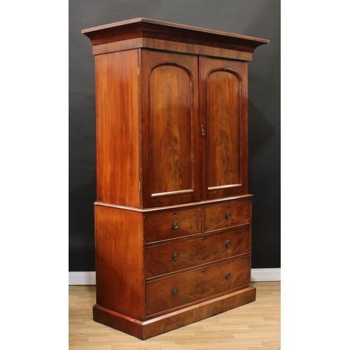 119 - A Victorian mahogany linen press, concave moulded cornice above a pair of arched panel doors enclosi... 