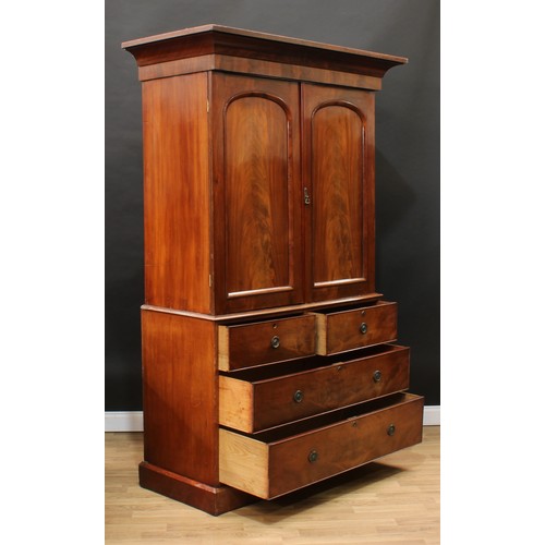 119 - A Victorian mahogany linen press, concave moulded cornice above a pair of arched panel doors enclosi... 