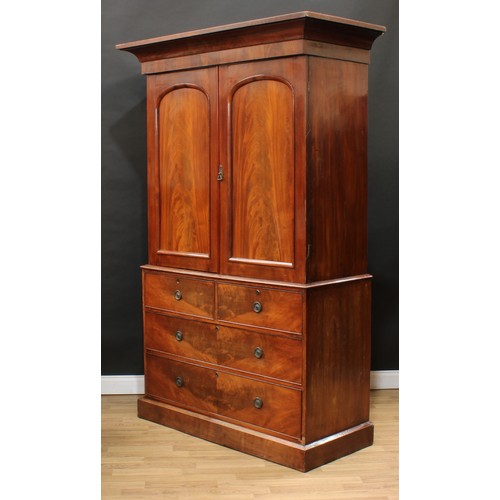 119 - A Victorian mahogany linen press, concave moulded cornice above a pair of arched panel doors enclosi... 