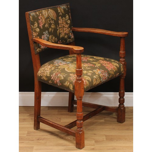 123 - A set of six Cromwellian Revival oak dining chairs, comprising a pair of carvers and six side chairs... 
