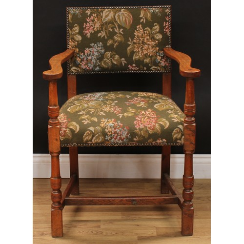 123 - A set of six Cromwellian Revival oak dining chairs, comprising a pair of carvers and six side chairs... 