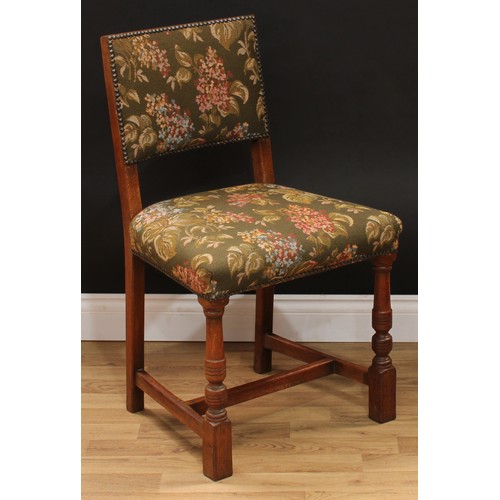 123 - A set of six Cromwellian Revival oak dining chairs, comprising a pair of carvers and six side chairs... 