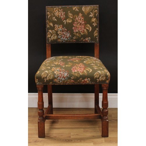 123 - A set of six Cromwellian Revival oak dining chairs, comprising a pair of carvers and six side chairs... 