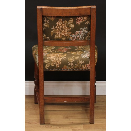 123 - A set of six Cromwellian Revival oak dining chairs, comprising a pair of carvers and six side chairs... 