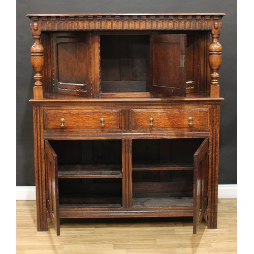 128 - A 17th century style oak duodarn or court cupboard, rectangular top above a nulled frieze and a rect... 