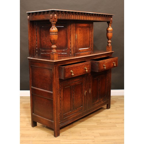 128 - A 17th century style oak duodarn or court cupboard, rectangular top above a nulled frieze and a rect... 