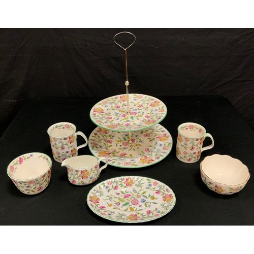 188 - A Minton Haddon Hall pattern six setting dinner and tea set with some spares inc two tier cakes stan... 