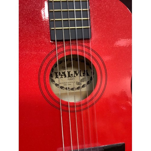 205 - A Yamaha F-310 six string acoustic guitar;  Mahalo U30G red Ukulele;  a childs Palma PJROFT guitar, ... 